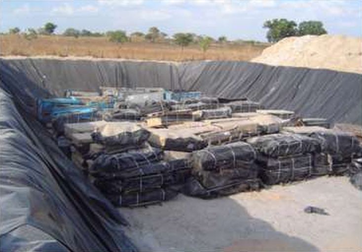 Encapsulated waste placed in the lined cell of a security landfill.