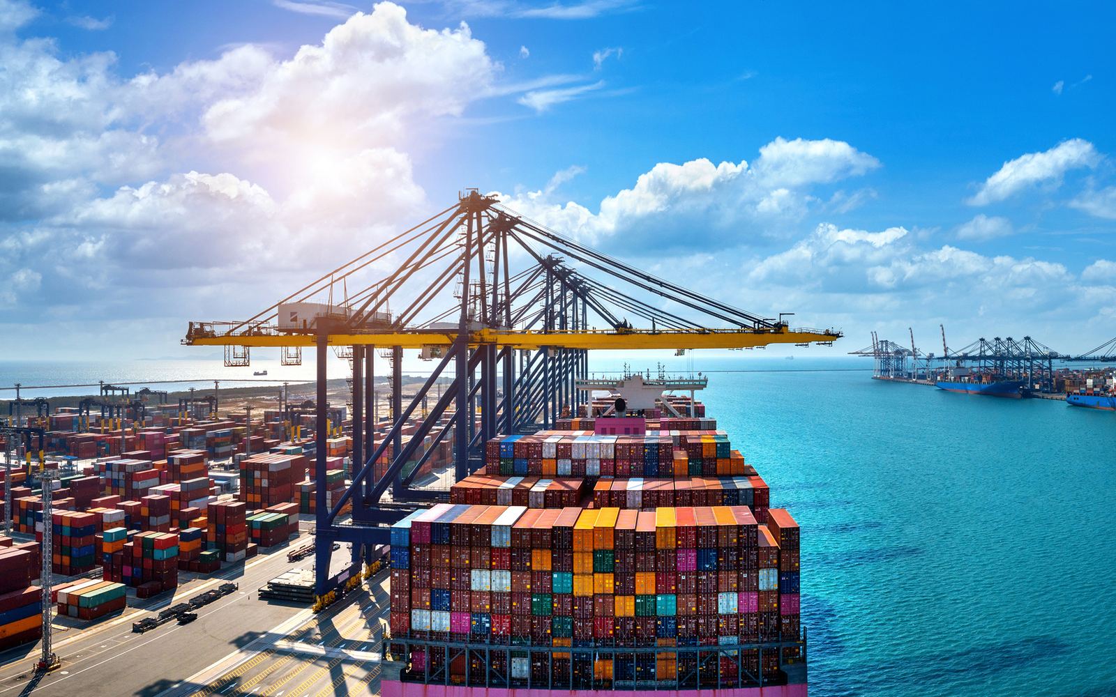 Container ship berthed at a terminal with ship-to-shore cranes