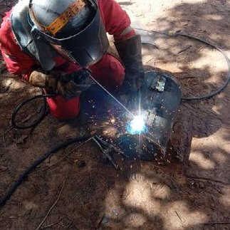 Tanzaca welder joining a crude oil pipe in the field