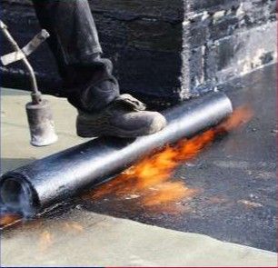 Waterproofing with an asphalt membrane applied with a torch.