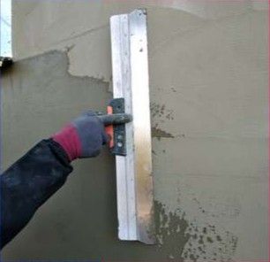 Coating applied with a metal trowel on a wall.