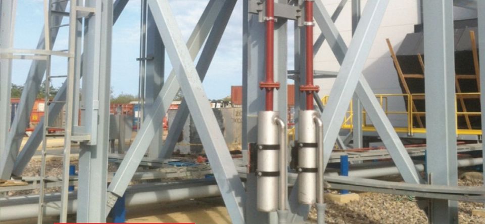 Steel structure with piping and vertical cylindrical equipment.